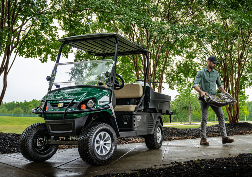 man taking mulch out of cart