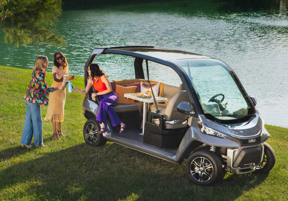 woman enjoying drinks together on cart by water