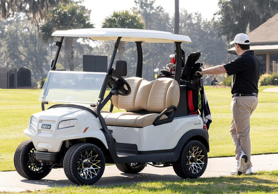 man standing next to golf cart